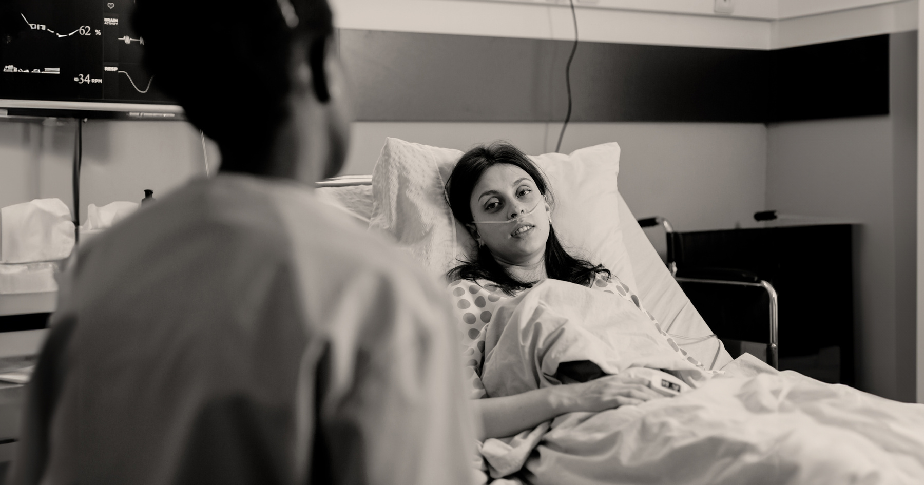 woman lying in hospital bed