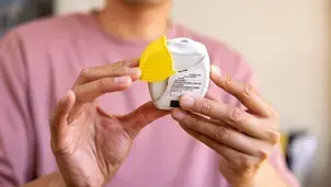 Person holding a fluticasone and vilanterol inhaler.