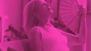 Woman using a fan to cool down