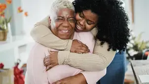 Woman hugging an older person
