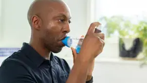 Man using an inhaler