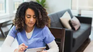 Health professional using a laptop