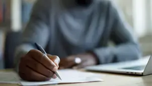 Man writing on paper