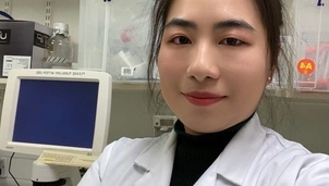 A woman in her lab coat
