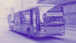 A modern city bus in motion, with a blurred urban background, tinted in blue and purple hues