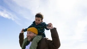Man holding a child on his shoulders
