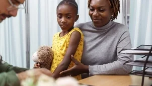 Child sitting on their parents lap at the doctors