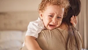 Person holding a crying baby