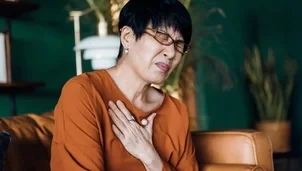 A woman clutching her chest