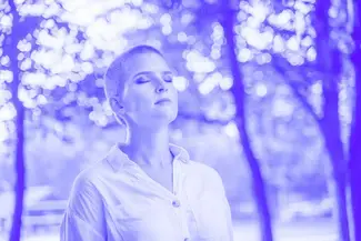 Woman breathing deeply in a forest