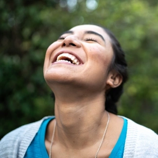 woman smiling at the sky
